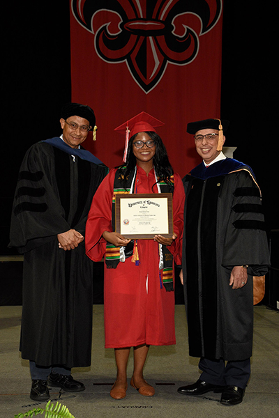 Dr. Rafael Hernandez, department head of chemical engineering, Vanel Porter, and Dr. Ahmed Khattab, College of Engineering dean at commencement