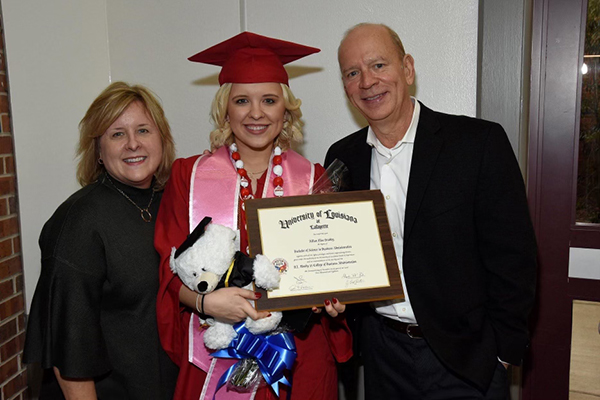 Jillian with her parents after finishing her undergraduate degree.