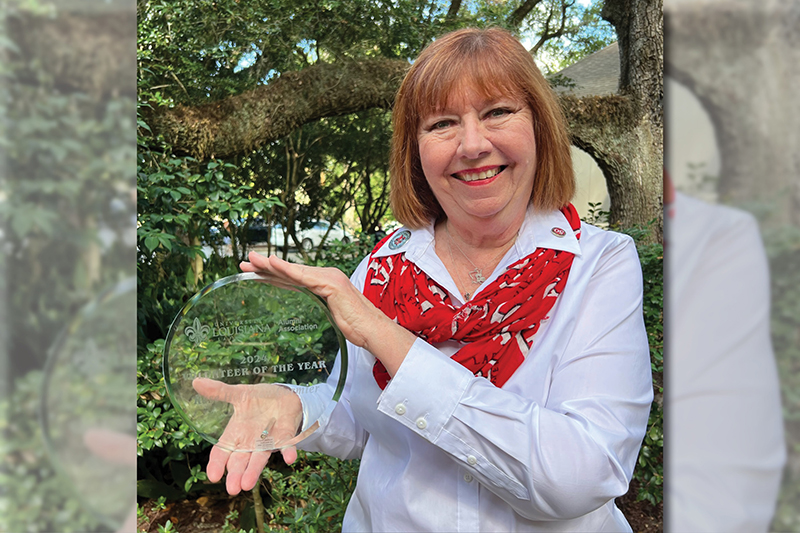 Rose Hoffman Corimier shows off her Volunteer of the Year Award at the Alumni Center.