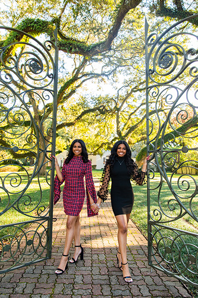 Senior photography of two females at Alumni Center gates by Yusef Davis